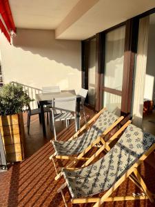 a balcony with chairs and a table on a balcony at T3 - Centre - 75m2 - 2 SDB - Parking - Calme in Anglet