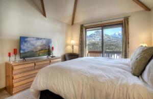 a bedroom with a large bed and a large window at Cascade Village 59 in Durango Mountain Resort +35 photos