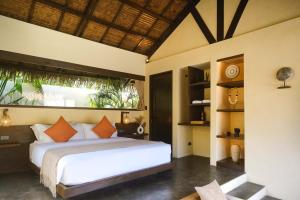 a bedroom with a white bed and a large window at Nala Villas in General Luna +40 photos