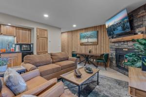 a living room with a couch and a fireplace at Bend Mt Bachelor Village Condo! in Bend
