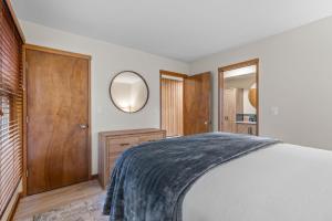 a bedroom with a bed and a mirror at Bend Mt Bachelor Village Condo! in Bend +18 photos