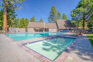 a swimming pool in front of a house at Bend Mt Bachelor Village Condo! in Bend