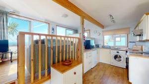 a kitchen with a counter and a stove top oven at C23 Wilmar, Riviere Towans in Hayle