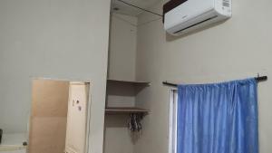 a kitchen with a refrigerator and a heater and a window at Apartamentos Emanuel in San Benito