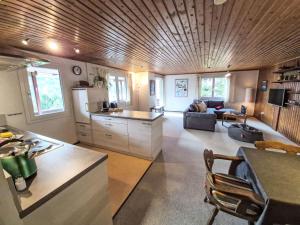 a large kitchen and living room with a couch at Apartment Crap Grisch by Interhome in Ruschein