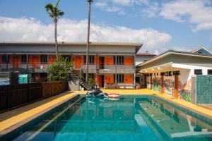 a house with a swimming pool in front of a building at Revolution Hostel Pai in Pai