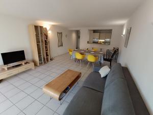 a living room with a couch and a table at Apartment Le Magellan-2 by Interhome in Saint-Raphaël