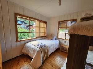 Ένα ή περισσότερα κρεβάτια σε δωμάτιο στο Cabaña Frutillar Bajo