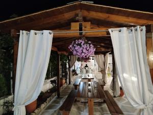 a wedding altar with white curtains and a chandelier at Harmony Apartments in Larisa