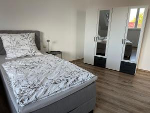 a bedroom with a bed and two mirrors at Ferienhaus Weimarer Land in Berlstedt