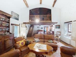 a living room with a couch and a table at Holiday Home Les Vidalières by Interhome in Saint-Sulpice-dʼArnoult