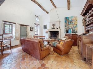 a living room with leather furniture and a fireplace at Holiday Home Les Vidalières by Interhome in Saint-Sulpice-dʼArnoult
