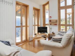 een woonkamer met witte meubels en ramen bij Apartment Schweizerheim Apt-5 by Interhome in Wengen