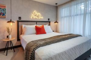 a bedroom with a large bed with a sign on the wall at Sueño Caleño in Cali