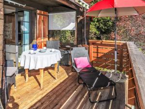 a wooden deck with a table and an umbrella at Apartment Jungfrau a d Ledi-1 by Interhome in Wengen