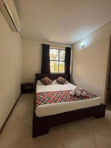 Una cama o camas en una habitación de Hotel Tierra Santa Santa Fe de Antioquia