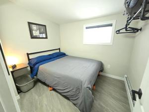 a small bedroom with a bed and a window at Cozy home on a quiet street minutes to DT Kingston in Kingston
