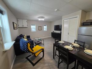 a living room with a couch and a dining room at Cozy home on a quiet street minutes to DT Kingston in Kingston