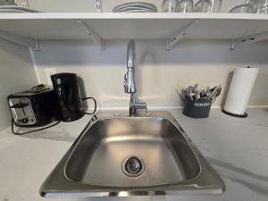 a kitchen counter with a sink in a kitchen at Cozy home on a quiet street minutes to DT Kingston in Kingston +25 photos