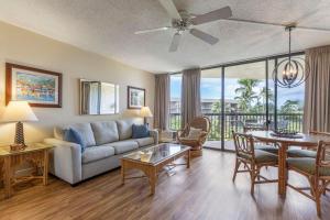 a living room with a couch and a table at Maui Sunset A413 in Kihei