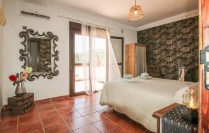a bedroom with a large bed and a mirror at Villa el Cortijo in Torrox