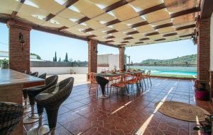 a patio with a table and chairs and a view at Villa el Cortijo in Torrox