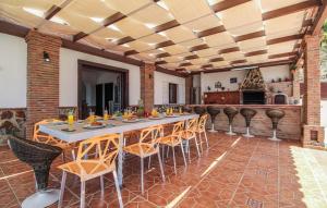a dining room with a long table and chairs at Villa el Cortijo in Torrox