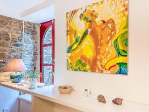 een schilderij aan de muur van een kamer met een bureau bij Holiday Home Arbenn 2 by Interhome in Tréguier