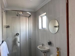 a bathroom with a shower and a sink at Awezi Overnight in Coldstream