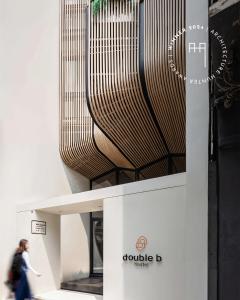 a woman walks past a display at a museum at Double B Hostel in Bangkok