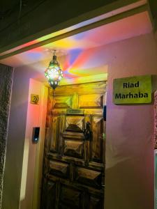 a door in a room with a neon light at Riad Marhaba in Marrakesh