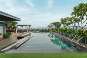 a swimming pool on the roof of a building with plants at The Fern, Jaipur, Series by Marriott in Jaipur