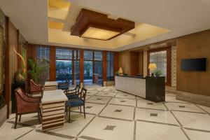 a lobby with a table and chairs and a television at The Fern, Jaipur, Series by Marriott in Jaipur