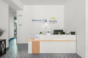 an office with a reception desk and a sign on the wall at Bluebird Suites at The Apex Miami in Miami Beach +81 photos