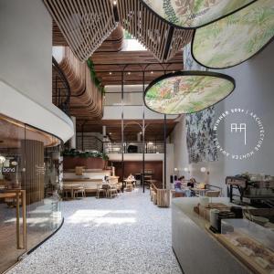 a rendering of the lobby of a restaurant with tables and chairs at Double B Hostel in Bangkok