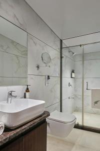 Un baño con lavabo, inodoro y ducha. en The Fern Sardar Sarovar Resort Kevadia, Gujarat, Series by Marriott, en Kevadia