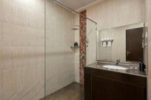 a bathroom with a sink and a glass shower at The Fern Residency, Bodhgaya, Series by Marriott in Bodh Gaya +16 photos