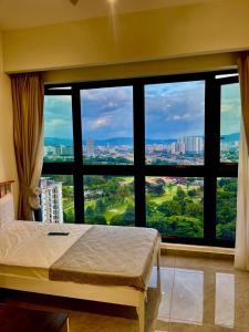 a bedroom with a large window with a view at Agile Residence Bukit Bintang by Skyline Homes in Kuala Lumpur