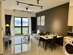 a kitchen and living room with a table and a couch at Agile Residence Bukit Bintang by Skyline Homes in Kuala Lumpur