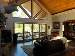 a living room with a couch and a large window at Torreon Getaway on the Greens with hot tub, 4 bedrooms, sleeps 10 in Show Low