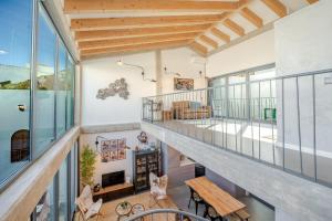 a room with a balcony with a table and chairs at The Warehouse - Industrial Loft in Faro
