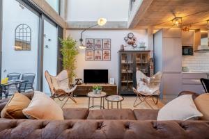 a living room with a couch and chairs at The Warehouse - Industrial Loft in Faro