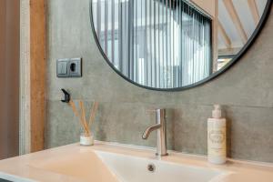 a bathroom with a sink and a mirror at The Warehouse - Industrial Loft in Faro +59 photos