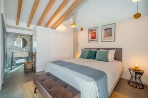 a bedroom with a large bed and a fireplace at The Warehouse - Industrial Loft in Faro