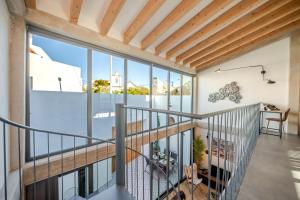 a view from the second floor of a house with glass windows at The Warehouse - Industrial Loft in Faro
