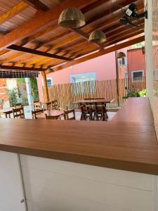 a bar in a restaurant with tables and chairs at Pousada Refúgio das Flores in Ubatuba +42 photos