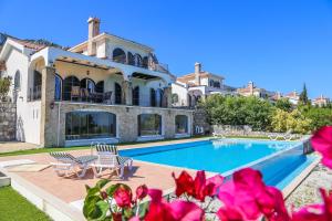 a large house with a swimming pool in front of it at Villa Sakura in Kyrenia