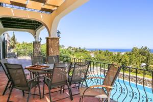 a patio with a table and chairs on a balcony at Villa Sakura in Kyrenia