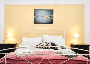 a bedroom with a bed with a painting on the wall at Gasparro House in Turi