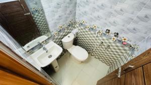 a small bathroom with a toilet and a sink at Hotel Prime City Residential in Dhaka